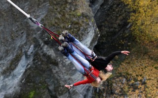 Kenny and Laura dangling from a bungee cord from the Kawarau Bridge - Queenstown, NZ