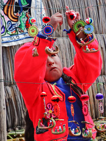 Girl displaying her crafts on the floating island of Uros