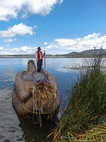 Man on his totora reed boat on the floating islands of Uros