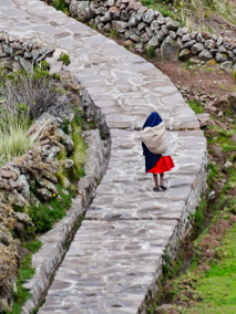 Woman walking down a pathway on Taquile Island