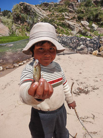 Child displays fish on Taquile Island