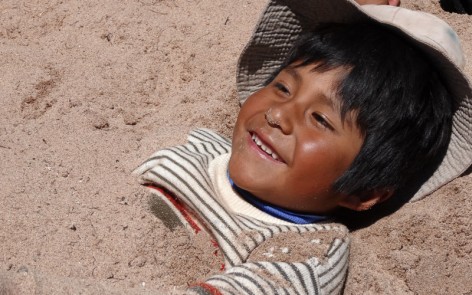 Wilfredo happily buried in the sand