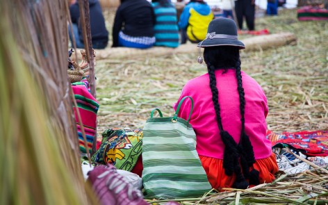 Woman with braided hair on the floating islands of Uros, Peru