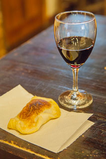 Wine glass and empanada in a Mendoza winery