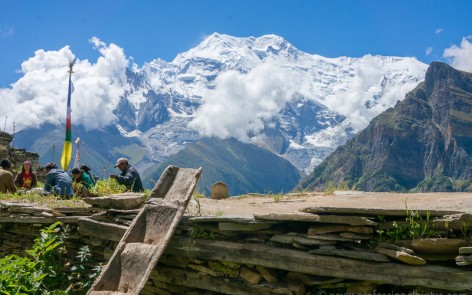 Locals working amid mountain views on Annapurna Circuit