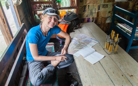 Laura in tea house studying map