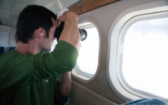 kenny taking a photo out the plane window