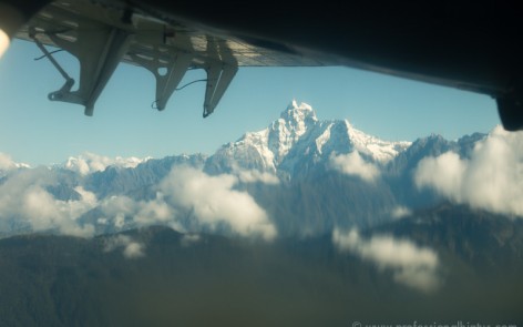 Himalayan mountain under a plane wing